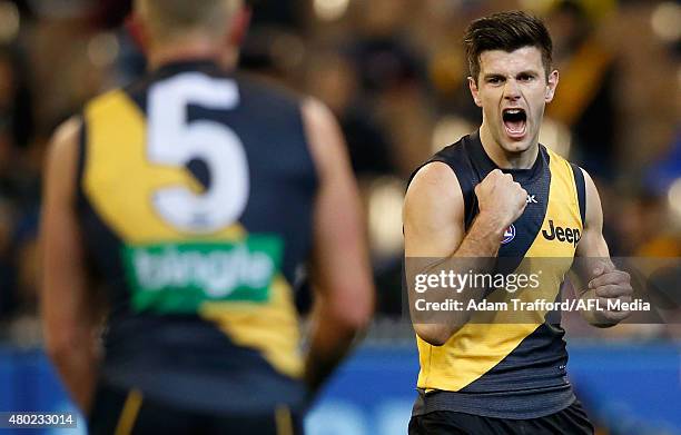 Trent Cotchin of the Tigers celebrates a goal during the 2015 AFL round 15 match between the Richmond Tigers and the Carlton Blues at the Melbourne...