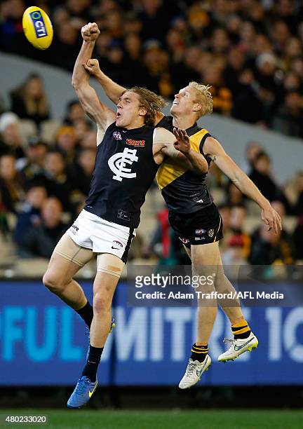 Tom Bell of the Blues and Steven Morris of the Tigers compete for the ball during the 2015 AFL round 15 match between the Richmond Tigers and the...