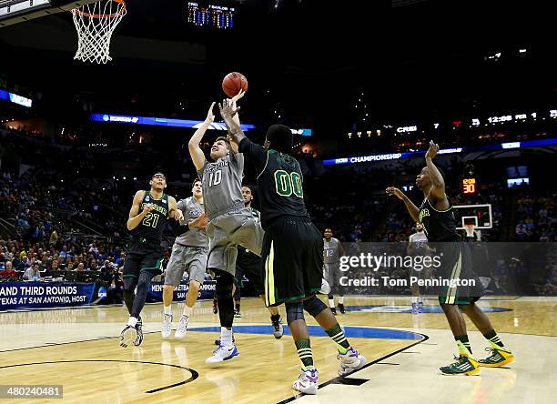 Grant Gibbs of the Creighton Bluejays goes to the basket as Royce O'Neale of the Baylor Bears defends during the third round of the 2014 NCAA Men's...