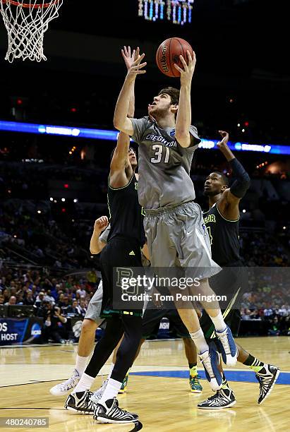 Will Artino of the Creighton Bluejays goes to the basket as Isaiah Austin of the Baylor Bears defends during the third round of the 2014 NCAA Men's...