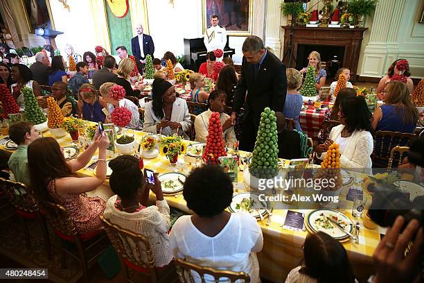 President Barack Obama drops by and shakes hands with attendees during the annual Kids State Dinner at the East Room of the White House July 10, 2015...