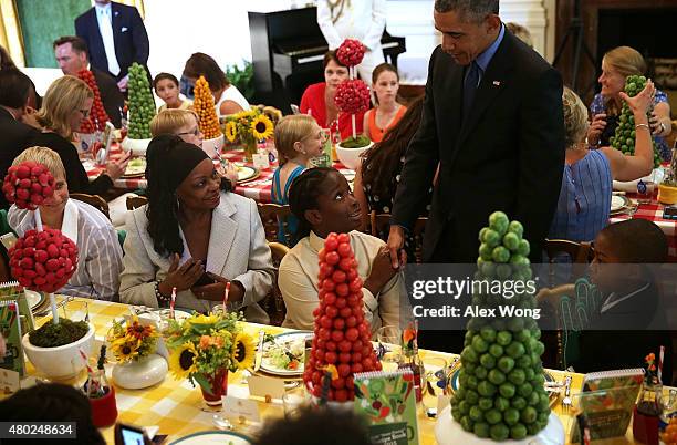 President Barack Obama drops by and shakes hands with attendees during the annual Kids State Dinner at the East Room of the White House July 10, 2015...