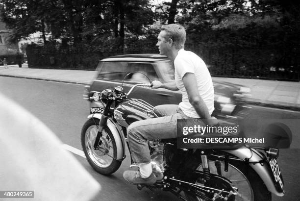 American actor Steve McQueen riding a Triumph TR6 Trophy motorcycle in London, 11th September 1963.