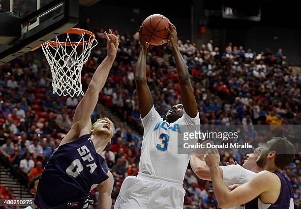 Jordan Adams of the UCLA Bruins shoots over Thomas Walkup of the Stephen F. Austin Lumberjacks in the second half during the third round of the 2014...