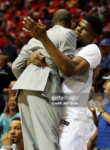 Director of Basketball Operations Tyus Edney celebrates with Tony Parker of the UCLA Bruins as they defeat the Stephen F. Austin Lumberjacks 77 to 60...