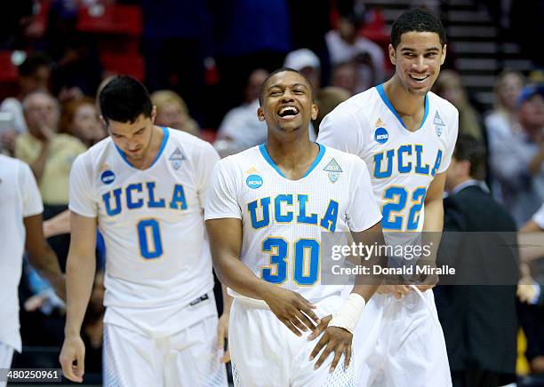 Aubrey Williams Nick Kazemi and Noah Allen of the UCLA Bruins celebrate their 77 to 60 win over the Stephen F. Austin Lumberjacks during the third...