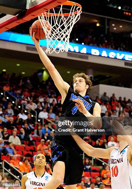 Austin Nichols of the Memphis Tigers drives to the basket against Mike Tobey of the Virginia Cavaliers in the second half during the third round of...