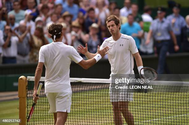 Switzerland's Roger Federer shakes hands after beating Britain's Andy Murray during their men's semi-final match on day eleven of the 2015 Wimbledon...