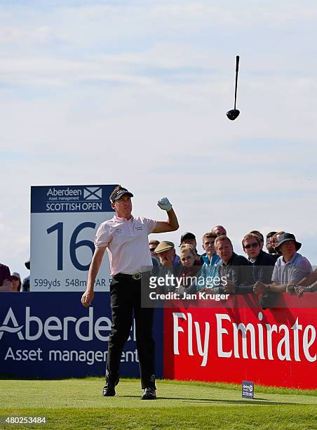 Ian Poulter of England tosses his club in the air after hitting his tee shot on the 16th hole during the second round of the Aberdeen Asset...