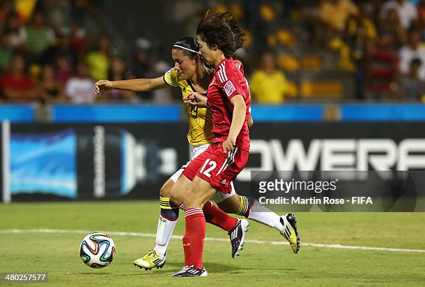 Angie Rodriguez of Colombia and Wei Yao of China battle for the ball during the FIFA U-17 Women's World Cup 2014 group D match between Paraguay and...