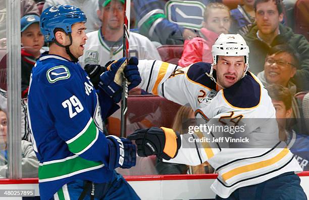 Tom Sestito of the Vancouver Canucks and Zenon Konopka of the Buffalo Sabres collide during their NHL game at Rogers Arena March 23, 2014 in...