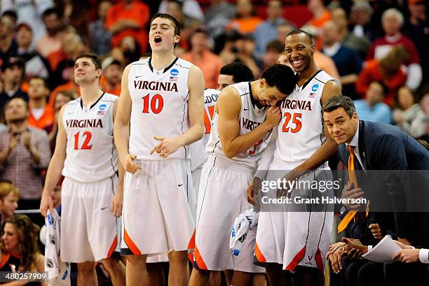 Joe Harris, Mike Tobey, Anthony Gill, Akil Mitchell and head coach Tony Bennett of the Virginia Cavaliers react late in the game against the Memphis...