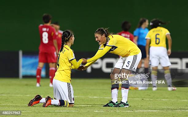 Sara Paez of Colombia celebrate with team mate Aylin Quinones during the FIFA U-17 Women's World Cup 2014 group D match between Paraguay and China at...