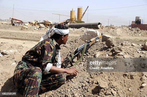 Yemeni soldiers stand guard at a checkpoint in the north Sanaa, Yemen on March 23, 2014. Nine people, including two Yemeni army soldiers, were killed...