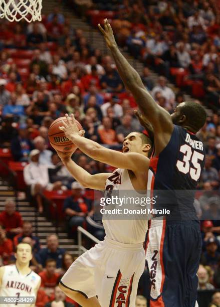 Nick Johnson of the Arizona Wildcats goes up against Sam Dower of the Gonzaga Bulldogs in the second half during the third round of the 2014 NCAA...