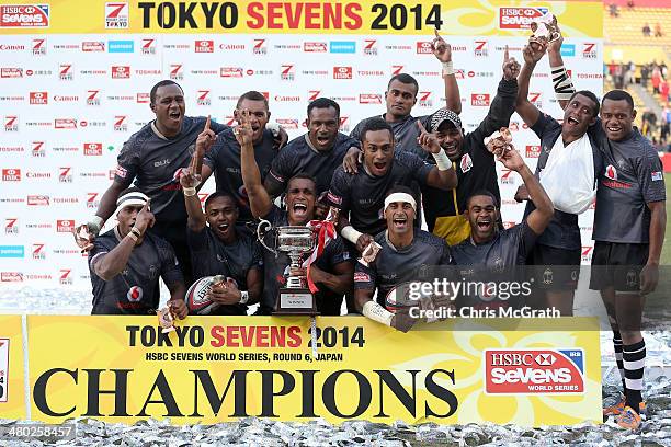 Fiji players celebrate with the trophy after defeating South Africa to win the Cup Final during the Tokyo Sevens, in the six round of the HSBC Sevens...