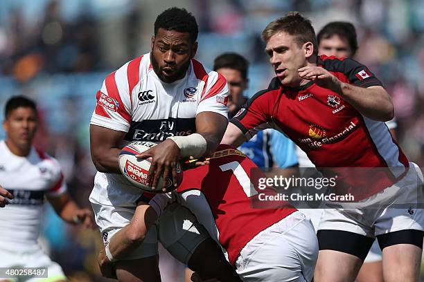 Andrew Durutalo of the USA is tackled by Sean White of Canada during the Tokyo Sevens, in the six round of the HSBC Sevens World Series at the Prince...