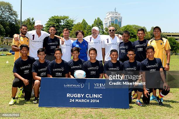 Laureus Academy Members Sean Fitzpatrick, Alexey Nemov, Daley Thompson and Morne du Plessis and CEO of YR1M Ung Su Ling pose with players and coaches...