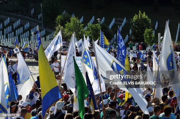 Several thousands of Bosnians, waving Bosnia's national flags, take part in the "Srebrenica Peace March" arriving at the Potocari Memorial Center...