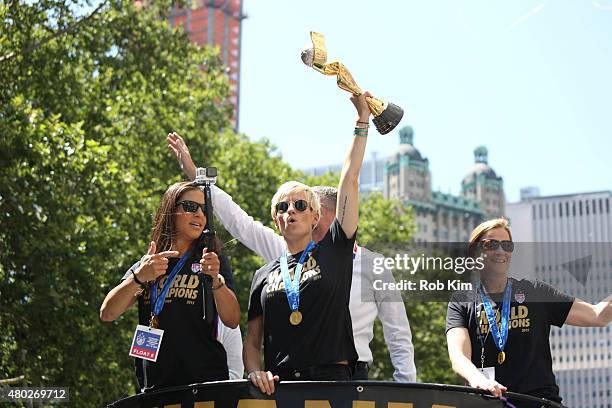 Mayor Bill de Blasio and wife Chirlane McCray ride a float with soccer players Carli Lloyd Megan Rapinoe, holding trophy, and head coach Jill Ellis...