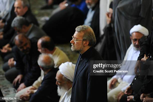 Ali Larijani, Iran's parliamentary speaker and former nuclear negotiator, stands during Friday Prayers during a Qods Day rally, an annual...