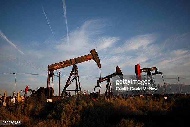 Pump jacks and wells are seen in an oil field on the Monterey Shale formation where gas and oil extraction using hydraulic fracturing, or fracking,...