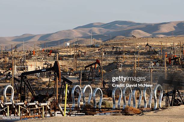 Pump jacks and wells are seen in an oil field on the Monterey Shale formation where gas and oil extraction using hydraulic fracturing, or fracking,...