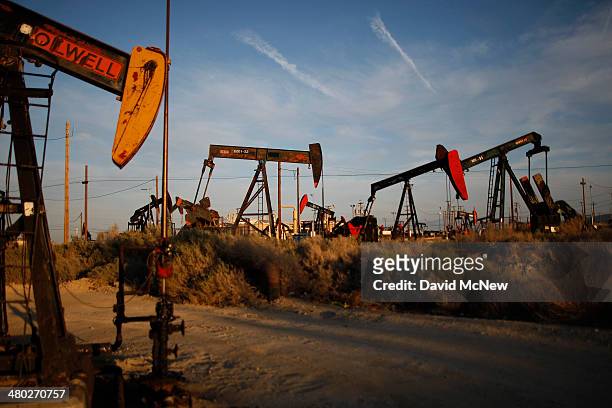 Pump jacks and wells are seen in an oil field on the Monterey Shale formation where gas and oil extraction using hydraulic fracturing, or fracking,...