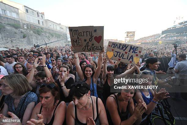 Music fans hold placards reading 'marry me Angus/Julia' during the concert of Australian brother-sister folk and indie pop group Angus & Julia Stone...