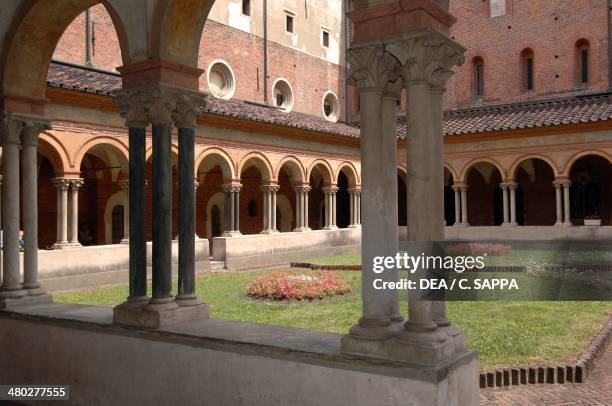 The arcades of the cloister supported by groups of four columns on a single base, Basilica of Sant'Andrea , Vercelli, Piedmont, Italy.