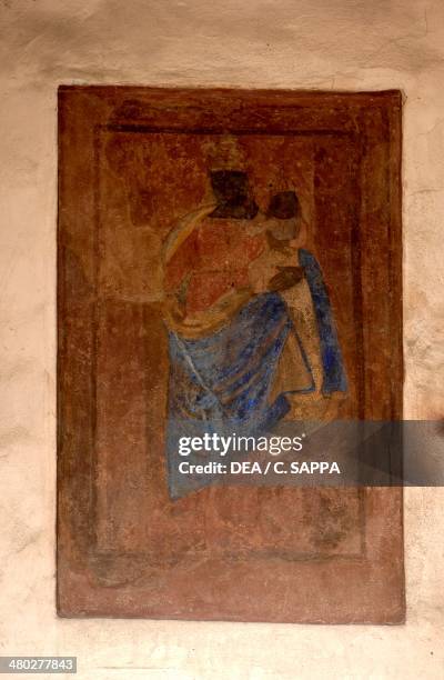 Madonna and Child , fresco on the facade of a building along the Costa del Vernato, medieval quarter in Piazzo, Biella, Piedmont, Italy.