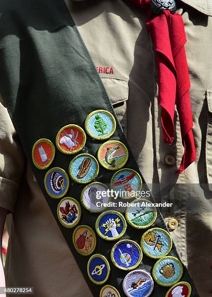 Boy Scout wears a sash displaying his earned merit badges at a ceremony in New York City. The merit badge sash is worn by a Boy Scout during formal...