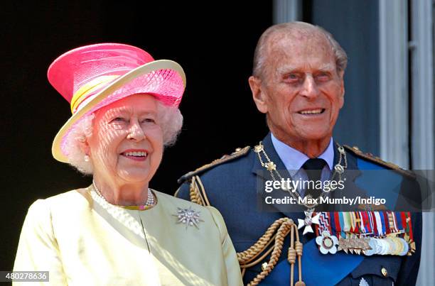 Queen Elizabeth II and Prince Philip, Duke of Edinburgh watch a flypast of Spitfire & Hurricane aircraft from the balcony of Buckingham Palace to...