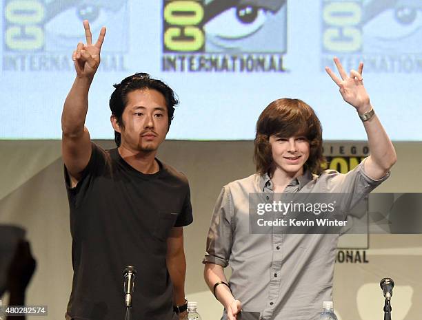 Actors Steven Yeun and Chandler Riggs speak onstage at AMC's "The Walking Dead" panel during Comic-Con International 2015 at the San Diego Convention...