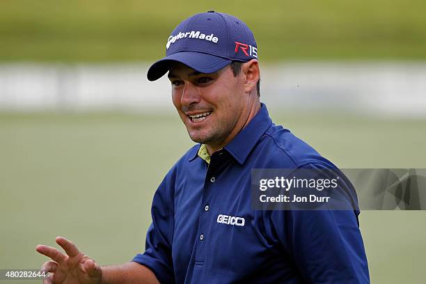 Johnson Wagner waves to the gallery after finishing the 18th hole during the second round of the John Deere Classic held at TPC Deere Run on July 10,...
