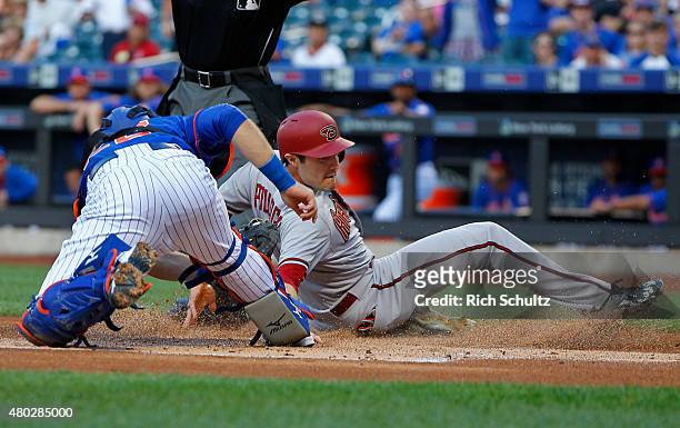 David Peralta of the Arizona Diamondbacks slides in safely with a run before catcher Kevin Plawecki of the New York Mets can make the tag on a...