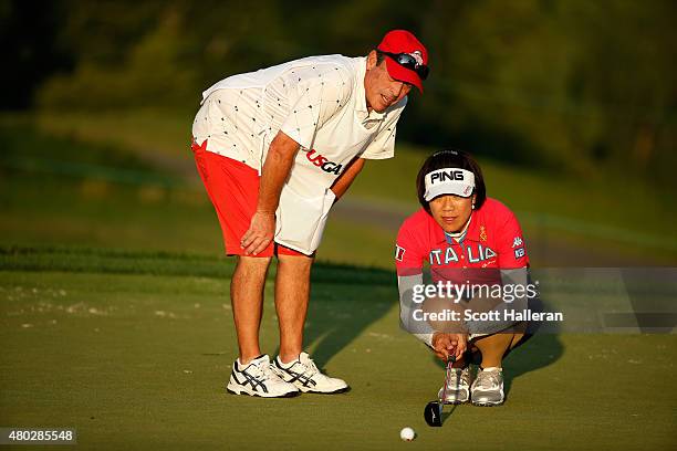 Shiho Oyama of Japan lines up putt with her caddie Dana Derouaux on the ninth green during the second round of the U.S. Women's Open at Lancaster...