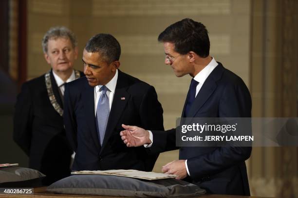 The Netherlands Prime Minister Mark Rutte, US President Barack Obama, and Amsterdam Mayor Eberhard van der Laan look at The Plakkaat, commonly known...
