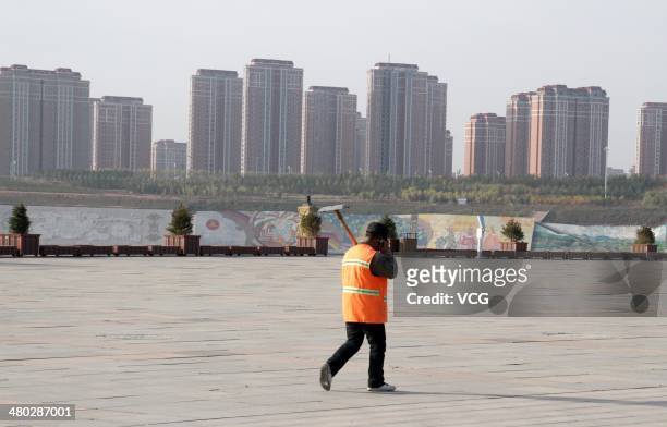 Man walks in front of residential blocks at Kangbashi District on October 16 in Ordos of Inner Mongolia Autonomous Region, China.