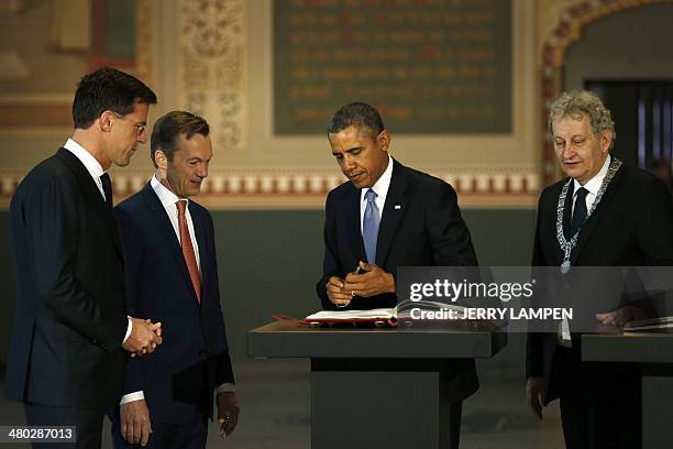 The Netherlands Prime Minister Mark Rutte , Wim Pijbes, Museum director, and the mayor of Amsterdam Eberhard van der Laan look at US president Barack...