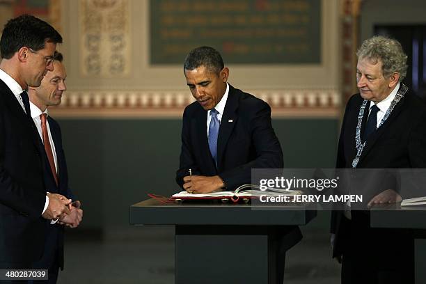 The Netherlands Prime Minister Mark Rutte , Wim Pijbes, Museum director, and the mayor of Amsterdam Eberhard van der Laan look at US president Barack...