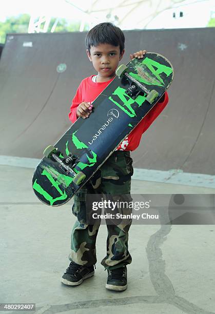 Young skateboarder poses as Laureus Academy Member Tony Hawk visits an urban skateboard park ahead of the Laureus World Sports Awards at Kiara Skate...