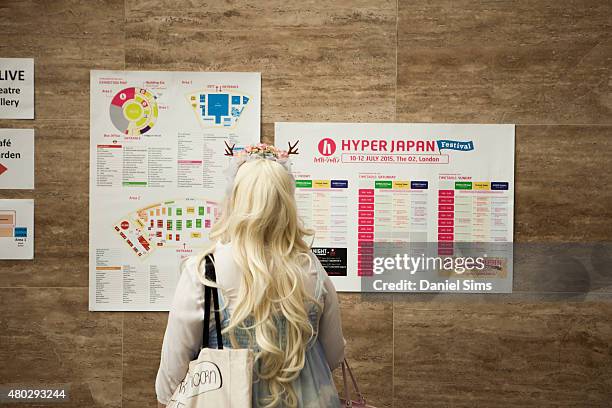 An attendee checks the schedule at Hyper Japan, the UK's biggest Japanese culture event on July 10, 2015 at The O2 Arena in London, England.