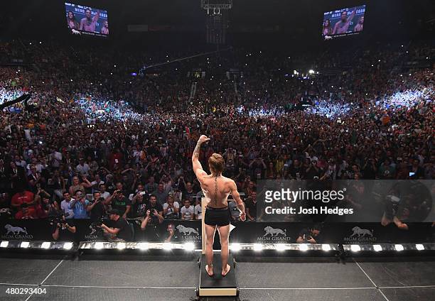 Conor McGregor steps onto the scale during the UFC 189 weigh-in inside MGM Grand Garden Arena on July 10, 2015 in Las Vegas, Nevada.