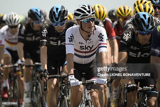 Great Britain's Peter Kennaugh rides in the pack with his teammates of the Great Britain's Sky cycling team, Australia's Richie Porte and...