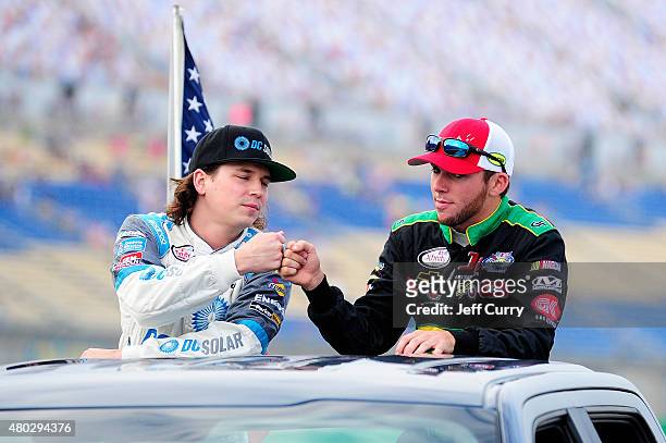 Brennan Poole, driver of the DC Solar Chevrolet, left, and Ross Chastain, driver of the Protect Your Melon Chevrolet, take part in pre-race...