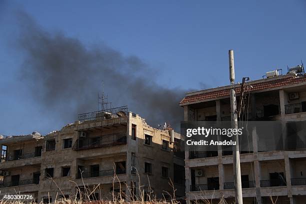 Smoke rises after forces connected to the Ansar Al-Sharia operations center attacked buildings containing regime forces in Cemiyet-ul Zehra...