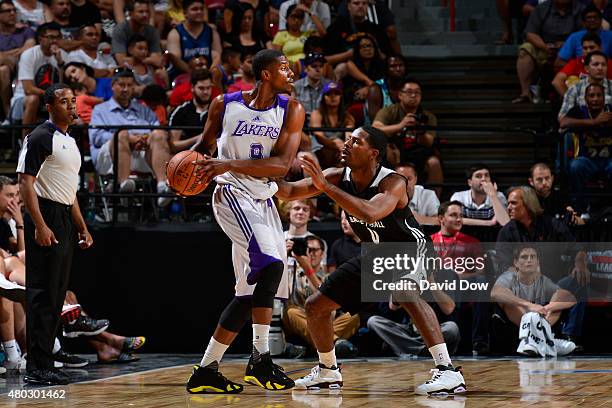 Tony Mitchell of the Los Angeles Lakers defends the ball against Othyus Jeffers of the Minnesota Timberwolves during NBA Summer League on July 10,...