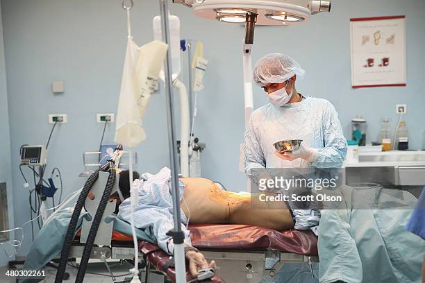 Soldier is prepped for abdominal surgery in the Paktia Regional Military Hospital at Forward Operating Base Thunder on March 24, 2014 near Gardez,...