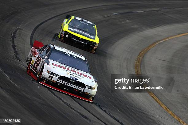 Brad Keselowski, driver of the Discount Tire Ford, leads Paul Menard, driver of the Richmond/Menards Chevrolet, during the NASCAR XFINITY Series...